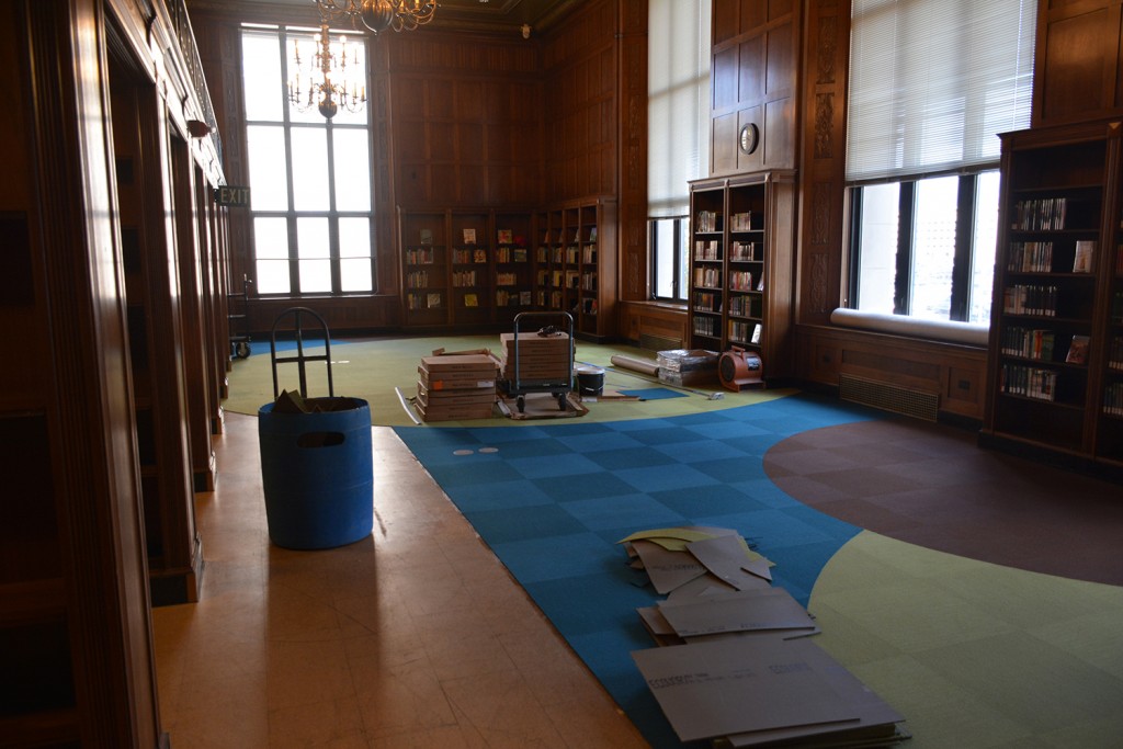 Progress: The new carpet being installed in the new Indiana Young Readers Center. The carpet brightens the room, but coordinates nicely with the natural colors of the woodwork original to the building.